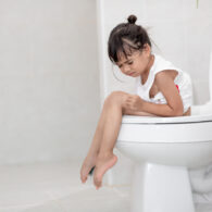 A child struggles with constipation — the books "The Ins and Outs of Poop" may help.