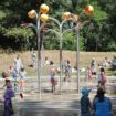 Spray park open with kids splashing around