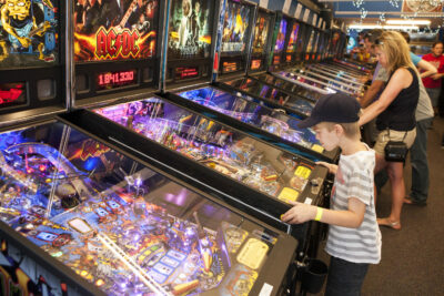 Child playing a vintage pinball machine at the Seattle Pinball Museum