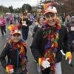 Families running in a Seattle-area Turkey Trot wearing festive Thanksgiving costumes and enjoying a community 5K event.