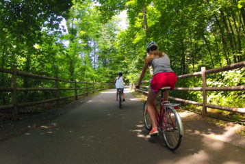 Child and parent biking on family-friendly trail near Seattle