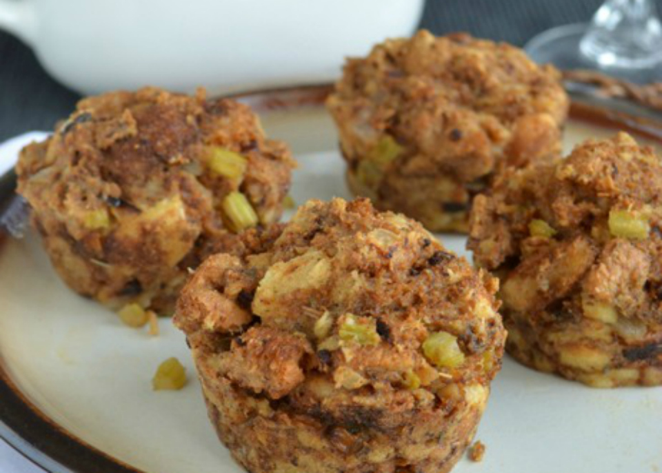 Individual Thanksgiving “stuffins” baked in a muffin tin, showing golden crispy edges and a mix of bread, pancetta, apples, and fennel.