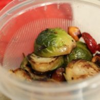 Bowl of veggie pasta tossed with chopped leftover Thanksgiving vegetables like Brussels sprouts, carrots, and green beans