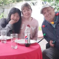 family eating outside with Christmas decor