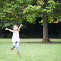 Picks. Girl jumping rope a park.