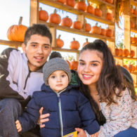 Pumpkin patch: Man, woman and child in front of pumpkins at Stocker Farm