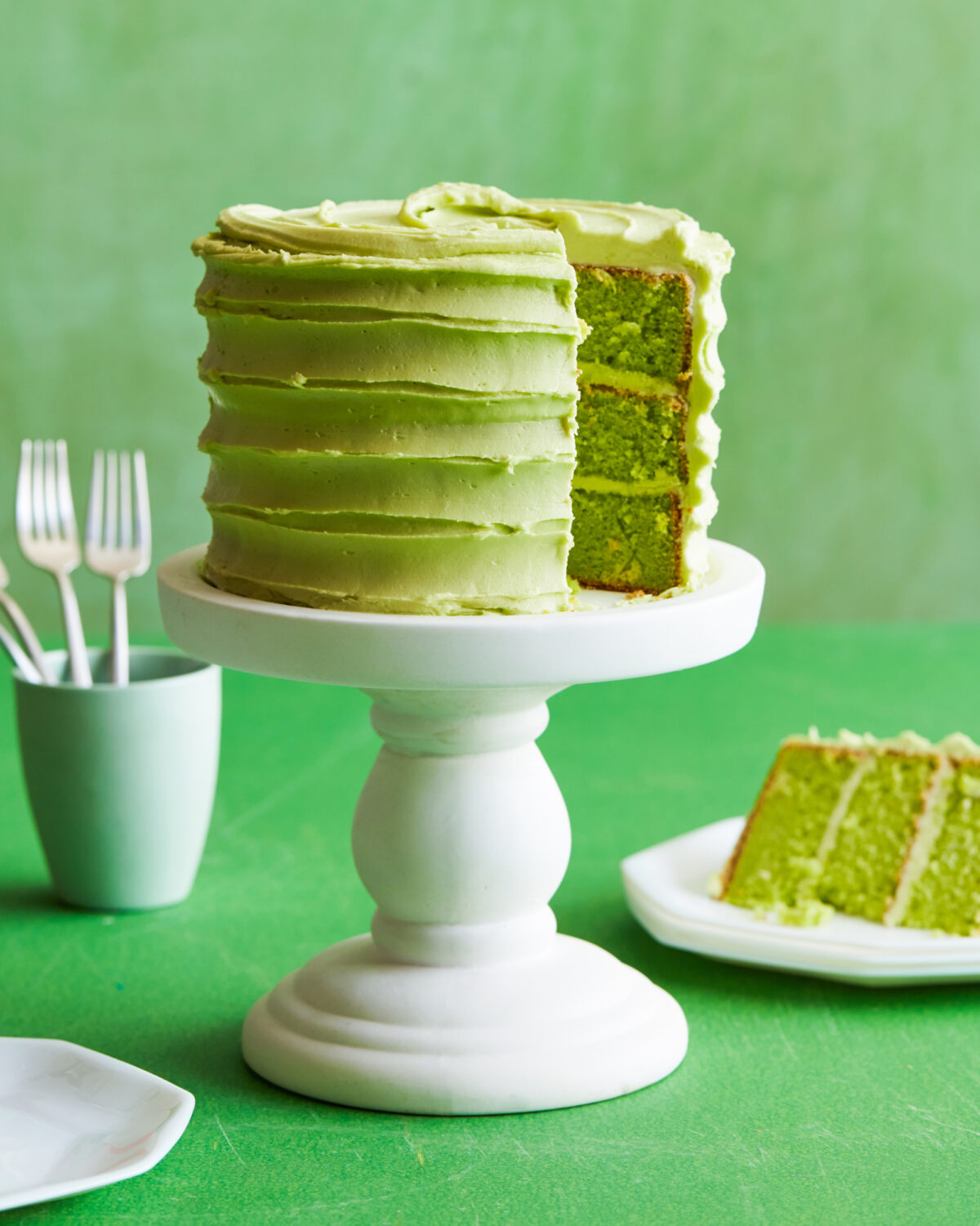 Green cake with slice missing