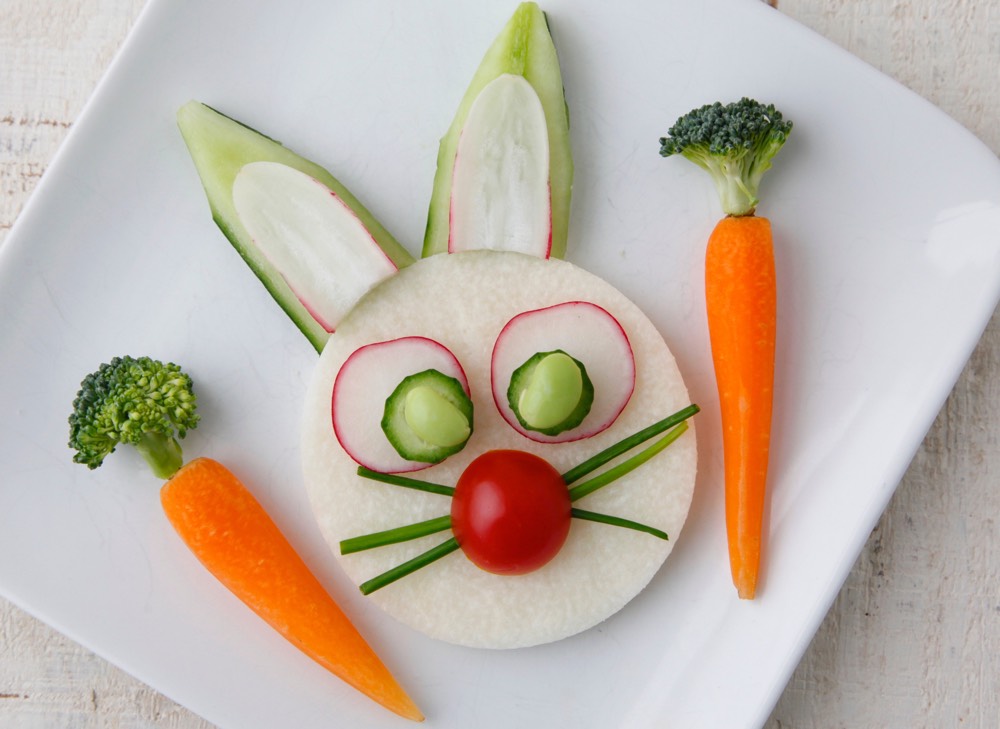 Bunny face on plate made with carrots, cucumbers, radishes, jicama and broccoli