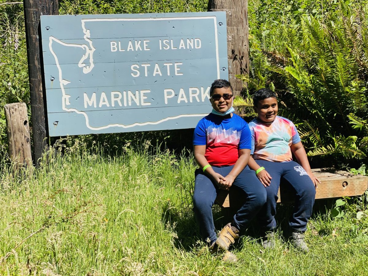 Children seated in front of the Blake Island State Park sign
