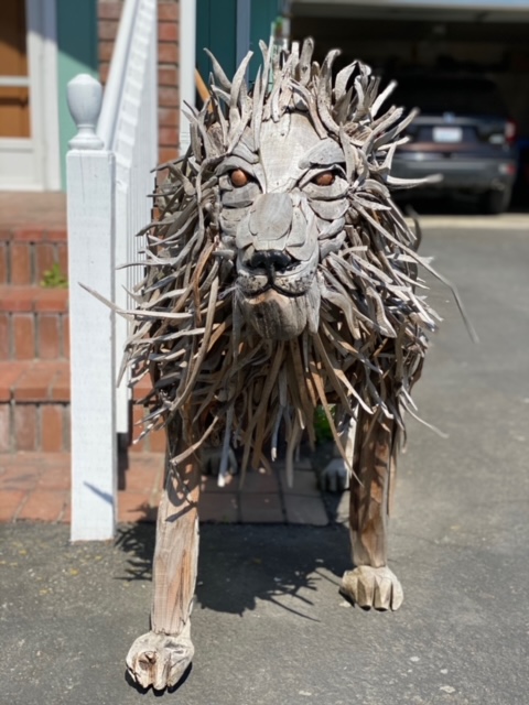A driftwood inspired lion guards the front of the house.