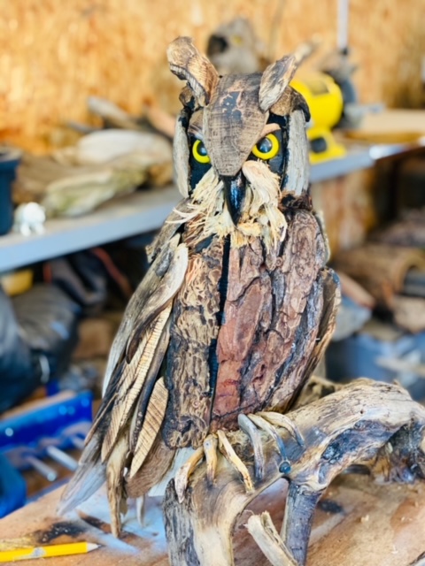 An owl made out of bark to represent the feathers.