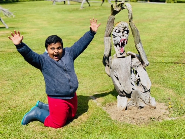 A zombie made out of driftwood emerges from the ground
