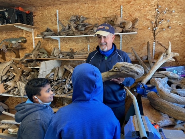 Artist describing a vision for a piece of driftwood.