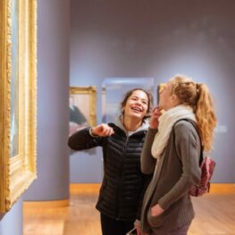 Two visitors laughing while viewing artwork at the Seattle Art Museum (SAM)