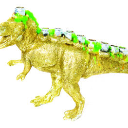 A handmade “Menorasaurus Rex” menorah — a bright, dinosaur-shaped hanukkiyah with candle holes along its back and big, toothy grin — ready for Hanukkah.