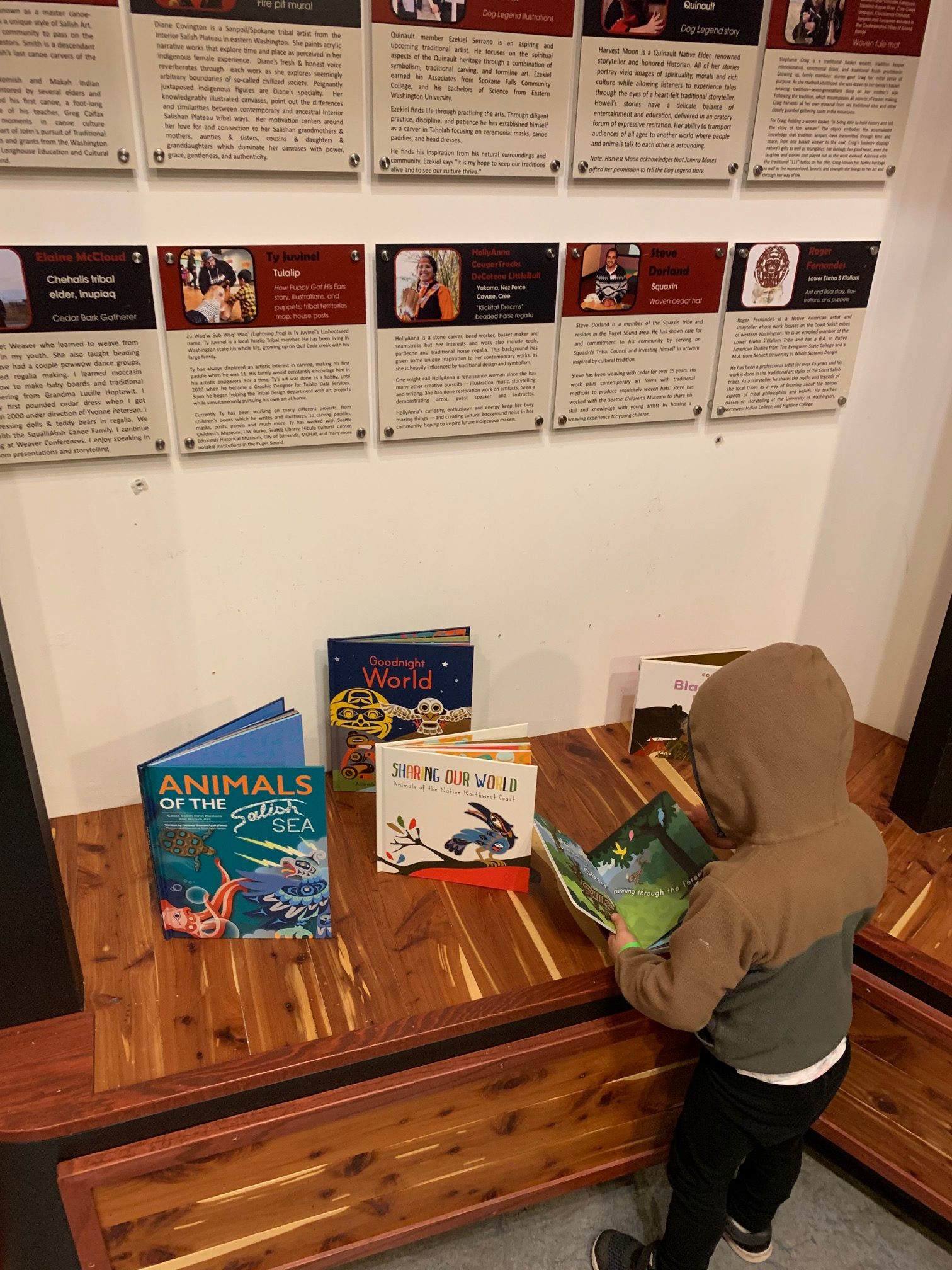 A child reads one of the many books at the museums reading nook.