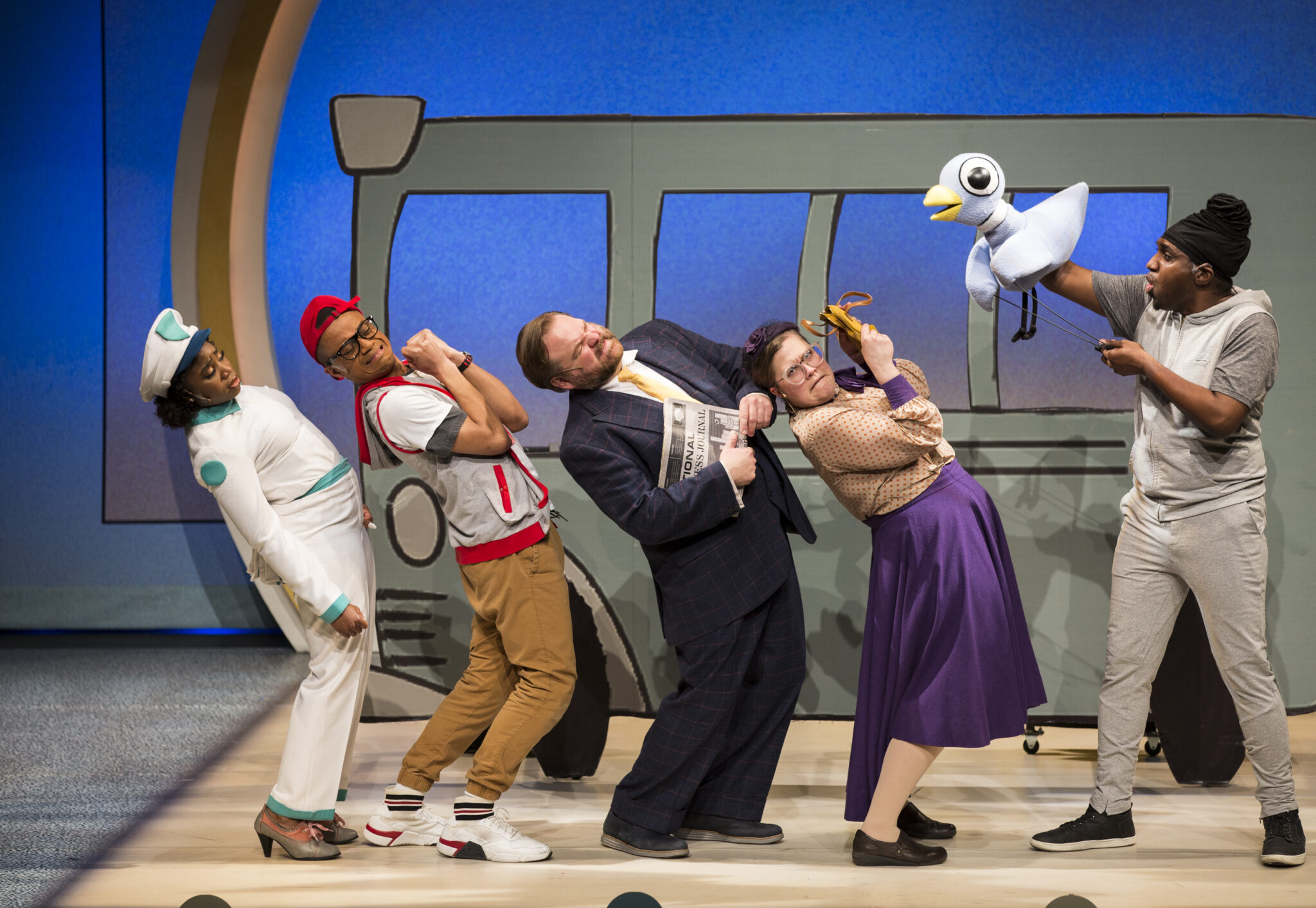 The cast react to the Pigeon's banter in the play.