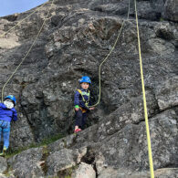 Two kids rock climbing