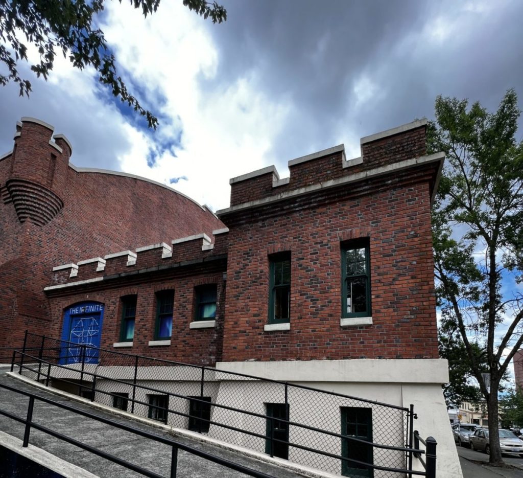 Building with a blue door. Behind the door is the VR experience