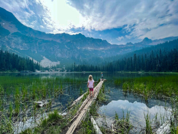 Child sitting by Cutthroat Lake in the North Cascades