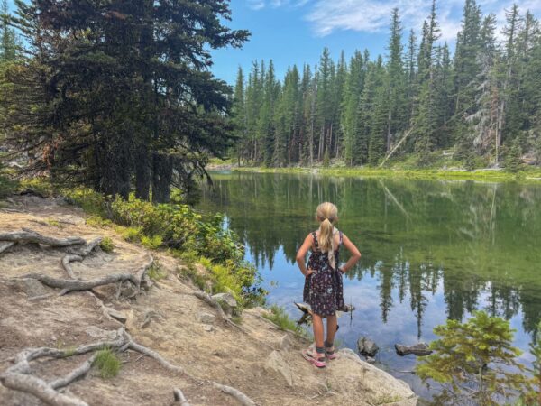 Girl looking out at fall colors at Clara and Marion Lakes trail
