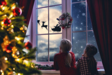 Illustration of kids looking out the window at Santa