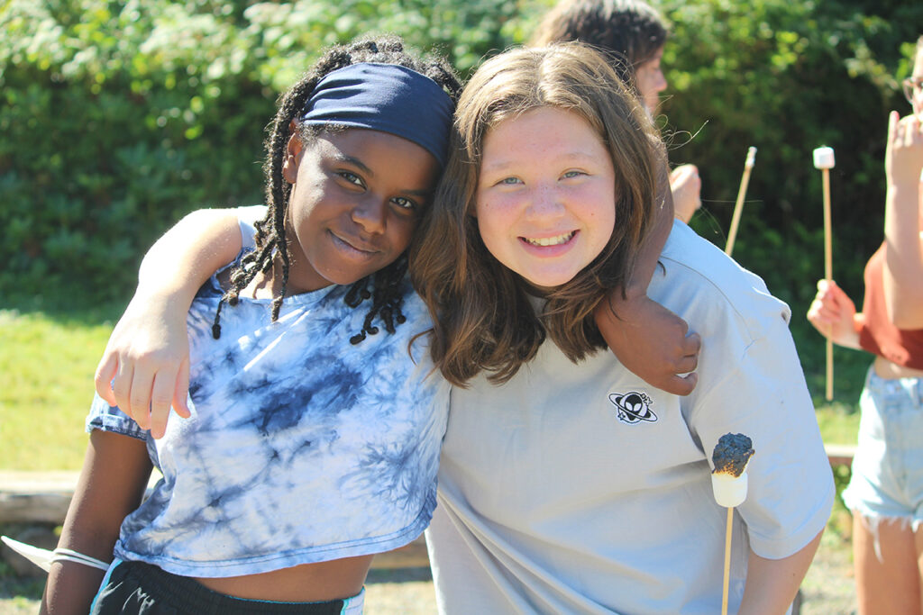 Two girls embracing to show friendships made at camp.