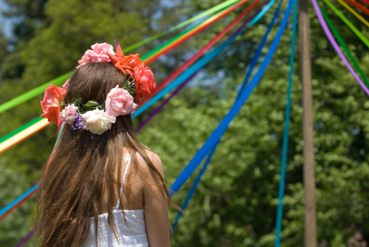 Girl with flowered headdress at a May Day Celebration