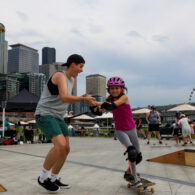 Girl learning to skateboard at Skate Like a Girl Pier 62
