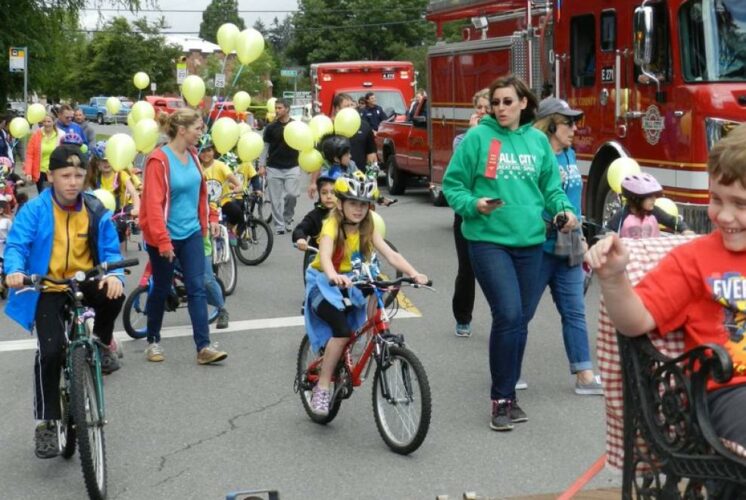 Kids bike and walk in the parade as a part of the Fall City Day Festival