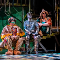 The lion Tin Man and Scarecrow sit with each other on the set of The Wonderful Wizard of Oz