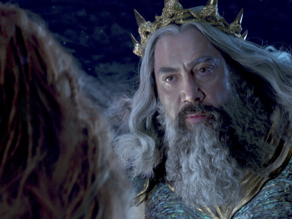 King Triton from the Little Mermaid in his crown facing his daughter, Ariel.