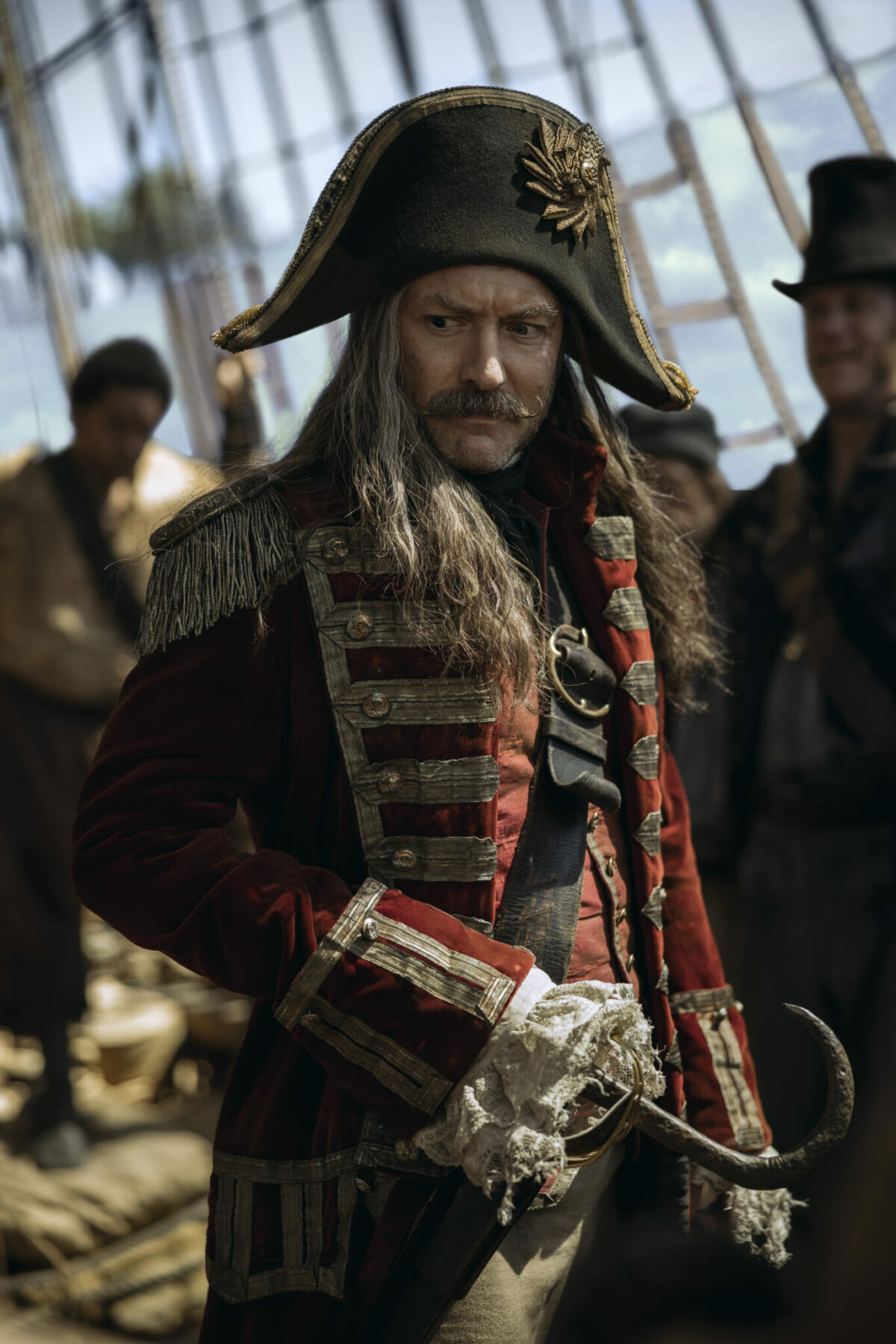 Jude Law as Captain Hook staring intently on his pirate ship