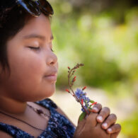 A girl practices mindfulness as she takes in the environment with all her senses