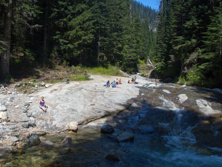People sitting Denny Creek Natural Waterslides