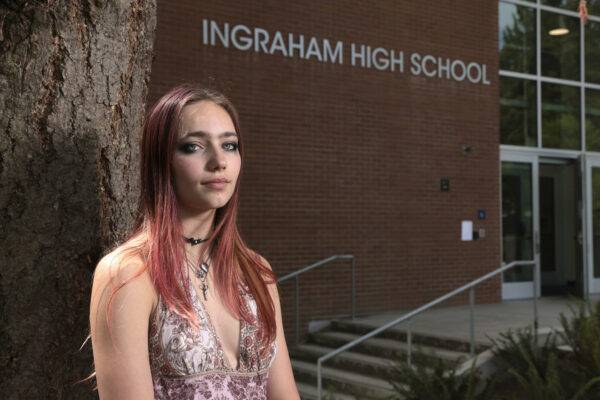 Seattle Student Union executive board member Noir Goldberg, 17, a junior at Ballard High School, is pictured outside Ingraham High School, where a student was shot and killed last fall, following a press conference announcing the launch of Reach Out Seattle.)