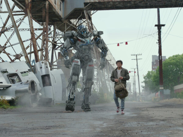 Human character walking alongside a Transformer
