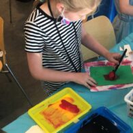 Child doing arts and crafts project at Family Art Days Nordic Museum.