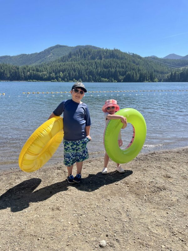 Two kids, with their floating tubes, ready to get into the lake at Lake Easton State Park.