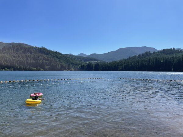 Two kids floating in the lake at Lake Easton State Park.