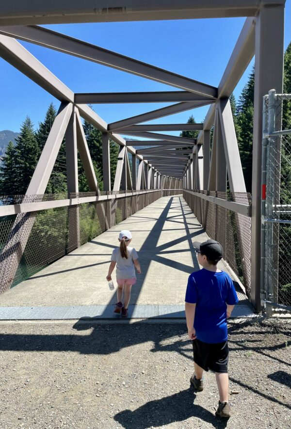 Kids crossing over a bridge on a walk around Lake Easton State Park.