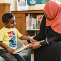 Mother and son looking at a book at the library