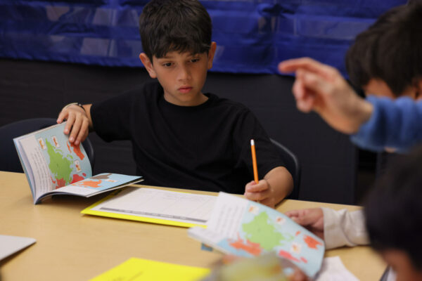 Refugees in schools boy learning english