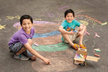 Agu and Mateo get creative with chalk at Bellevue Arts Fair