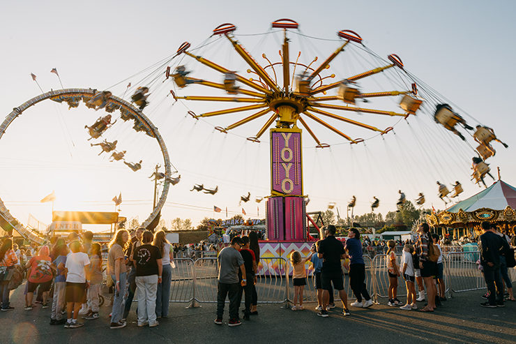 Sunset behind the Yoyo ride at the carnival at the Evergreen State Fair