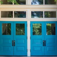 Exterior shot of front entry of school, with two blue double doors