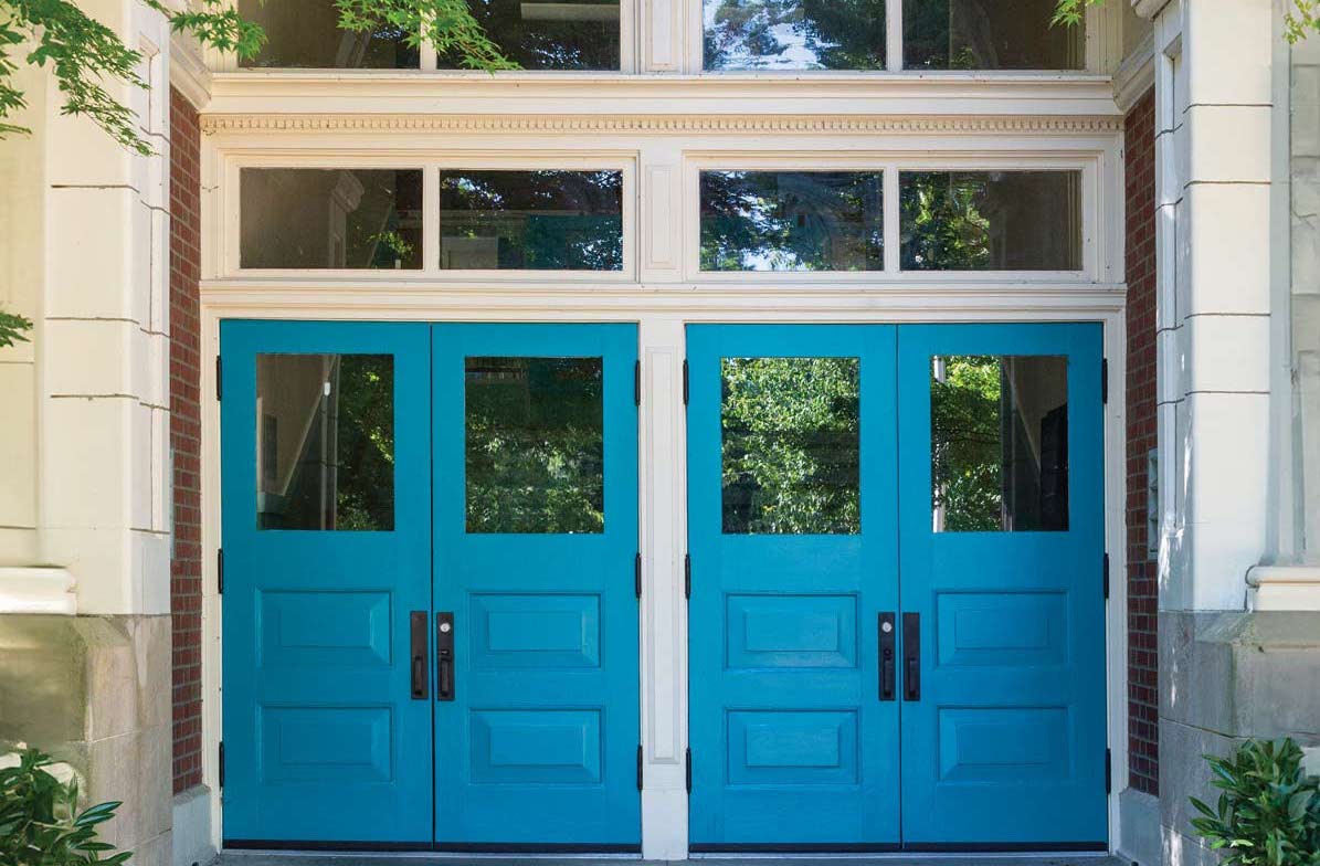 Exterior shot of front entry of school, with two blue double doors