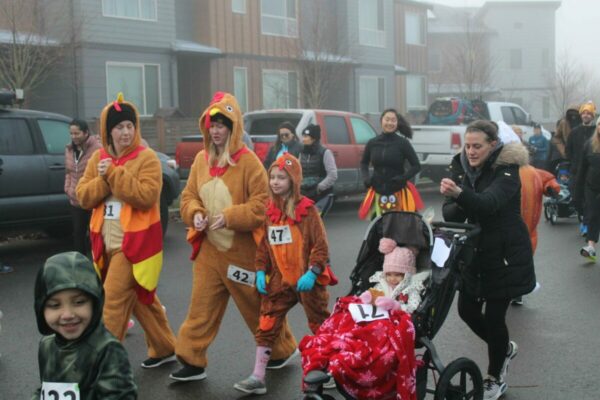 Families in costume running a fall fun run event in Seattle’s park