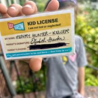 Kid holding up Kid License to camera