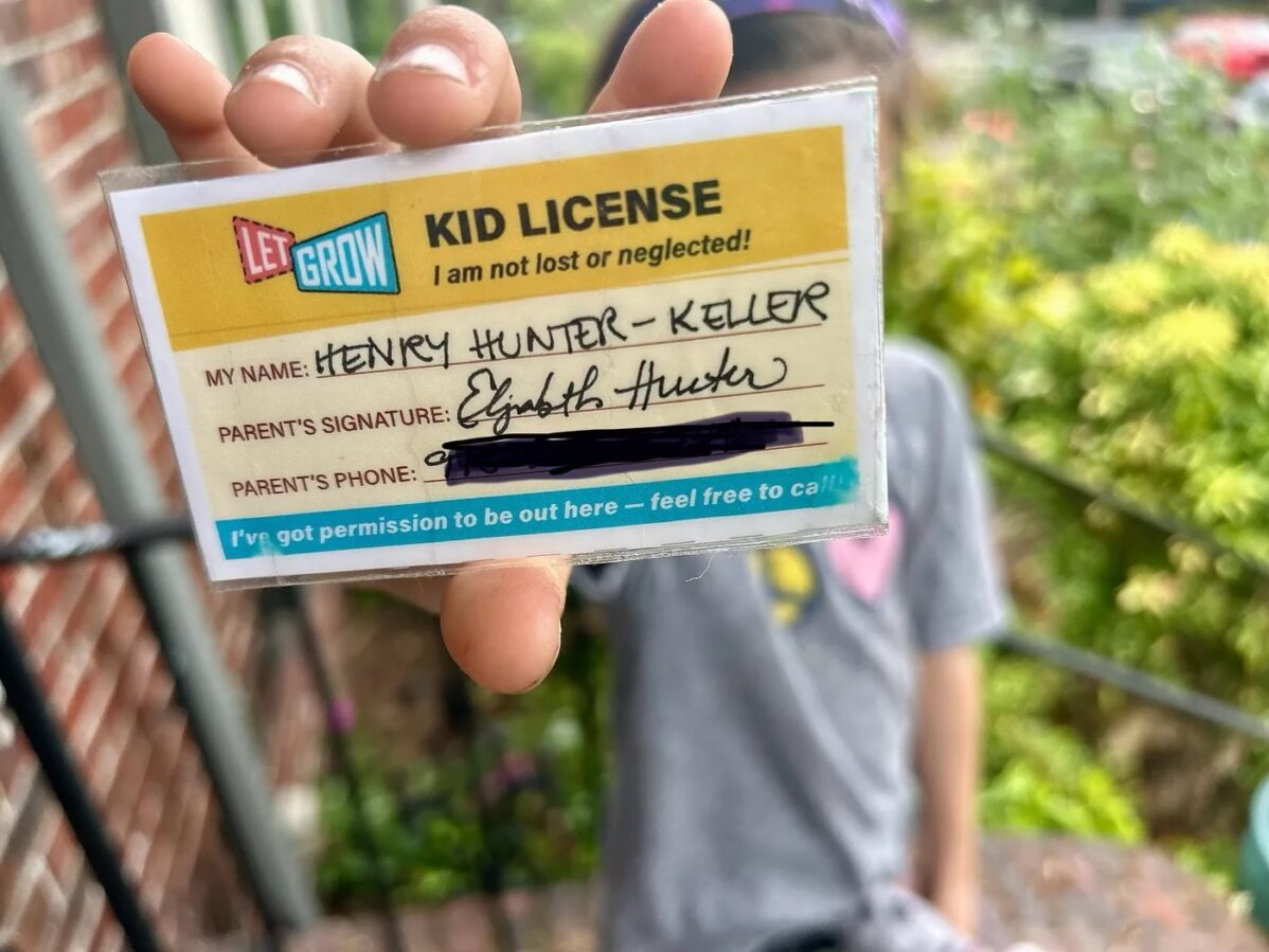 Kid holding up Kid License to camera